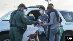 FILE - Migrants are processed by United States Border Patrol after crossing the US-Mexico border into the United States in Penitas, Texas on July 8, 2021. 