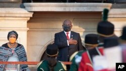 FILE - South African President Cyril Ramaphosa takes the national salute on his arrival at the City Hall in Cape Town, South Africa, Feb. 10, 2022 to deliver his State of The Nation Address.