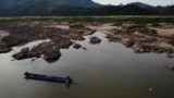 FILE - This aerial photo taken on Oct. 31, 2019, shows a fisherman on a boat on the drought-stricken Mekong river in Pak Chom district in the northeastern Thai province of Loei.