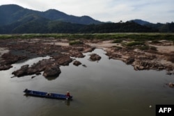 FILE - This aerial photo taken on Oct. 31, 2019, shows a fisherman on a boat on the drought-stricken Mekong river in Pak Chom district in the northeastern Thai province of Loei.