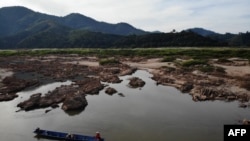 FILE - This aerial photo taken on Oct. 31, 2019, shows a fisherman on a boat on the drought-stricken Mekong river in Pak Chom district in the northeastern Thai province of Loei.