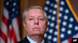 Sen. Lindsey Graham, R-S.C., waits to speak to reporters following bipartisan passage of the Ending Forced Arbitration of Sexual Assault and Sexual Harassment Act, at the Capitol in Washington, Feb. 10, 2022.