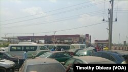 Many vehicles lockheads as they try to gain access into a fuel station as fuel shortage grips Abuja, Feb. 16, 2022.