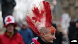 A protester with a Canadian flag painted in her hair walks the line as demonstrators continue to protest the COVID-19 mandates on Feb. 10, 2022 in Ottawa, Canada.