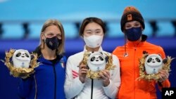 Gold medalist Choi Min-jeong, center, of South Korea, stands with silver medalist Arianna Fontana, left, of Italy, and bronze medalist Suzanne Schulting of the Netherlands, following the women's 1500-meters short track speedskating competition at the 2022