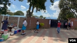 Some learners leave school in Chitungwiza, Zimbabwe, Feb. 10, 2022, when they discovered that teachers had not changed their minds about their strike after the government offered them a pay raise and incentives. (Columbus Mavhunga/VOA)