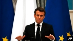 FILE - French President Emmanuel Macron speaks during a joint press conference with Russian President Vladimir Putin after their talks in Moscow, Feb. 7, 2022. 