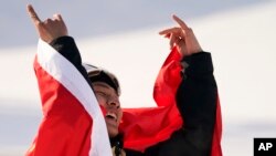 Su Yiming of China celebrates winning gold medal in the men's snowboard big air finals of the 2022 Winter Olympics, Feb. 15, 2022.