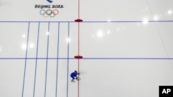 Nils van der Poel of Sweden crosses the finish line to break his own world record during the men's speedskating 10,000-meter race at the 2022 Winter Olympics, Feb. 11, 2022