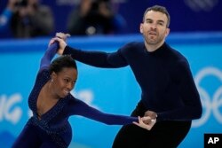 FILE - Vanessa James and Eric Radford, of Canada, compete in the pairs team free skate program during the figure skating competition at the 2022 Winter Olympics, Feb. 7, 2022, in Beijing.