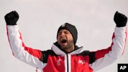 Johannes Strolz, of Austria, gold, celebrates during the medal ceremony for the the men's combined, Feb. 10, 2022.