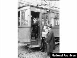 A man is stopped from riding a streetcar because he isn't wearing a face mask in Seattle, Washington, during the flu pandemic in 1918.