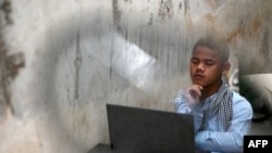 This photo taken on January 29, 2022, shows hip-hop artist Kea Sokun listening to one of his songs online at a cafe in Phnom Penh. . (Photo by TANG CHHIN Sothy / AFP)