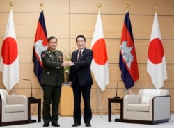 FILE - Commander of the Royal Cambodian Army Hun Manet, left, and Japan's Prime Minister Fumio Kishida fist bump at the start of their meeting at the prime minister's official residence in Tokyo Wednesday, Feb. 16, 2022.