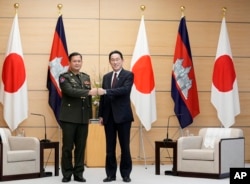 FILE - Commander of the Royal Cambodian Army Hun Manet, left, and Japan's Prime Minister Fumio Kishida fist bump at the start of their meeting at the prime minister's official residence in Tokyo Wednesday, Feb. 16, 2022.