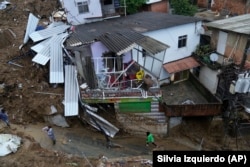 Damaged residences are seen after a landslide in Petropolis, Brazil, Wednesday, Feb. 16, 2022.