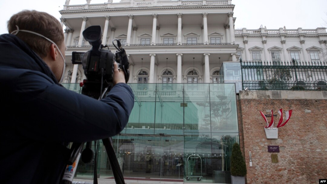 FILE - A cameraman films the Hotel Palais Coburg, venue of the meeting of countries party to the Iran nuclear deal, known as the Joint Comprehensive Plan of Action (JCPOA), in Vienna, Austria Feb. 8, 2022.