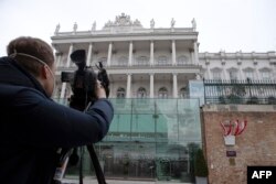 FILE - A cameraman films the Hotel Palais Coburg, venue of the meeting of the Joint Comprehensive Plan of Action (JCPOA), in Vienna, Feb. 8, 2022.