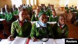 Priscilla Sitienei sits with her classmates during a lesson, January 25, 2022. REUTERS/Monicah Mwangi