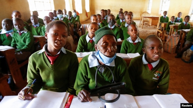 Priscilla Sitienei sits with her classmates during a lesson, January 25, 2022. REUTERS/Monicah Mwangi