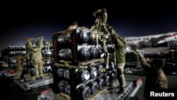 Ukrainian service members unpack Javelin anti-tank missiles, delivered by plane as part of the US military support package for Ukraine, at the Boryspil International Airport outside Kyiv, Ukraine, Feb. 10, 2022. 