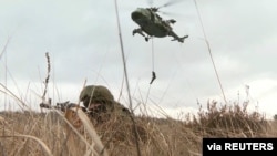 Servicemen of the armed forces of Russia and Belarus take part in the Union Courage 2022 joint military exercise at the Brestsky training ground in Brest Region, Belarus, in this still image taken from video released Feb. 11, 2022.