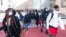 People leave Dunbar High School in Washington on Feb. 8, 2022, after Doug Emhoff, husband of Vice President Kamala Harris, was whisked out of a Black History Month event at the high school by Secret Service agents following an apparent bomb threat. 