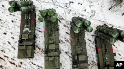 In this photo taken from video provided by the Russian Defense Ministry Press Service, Feb. 10, 2022, crews train with the S-400 air defense system in Belarus.