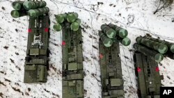 In this photo taken from video provided by the Russian Defense Ministry Press Service on Feb. 10, 2022, crews train with the S-400 air defense system in Belarus.