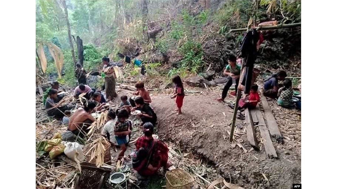 This handout photo from local media group Chin World taken in May 2021 and released on May 20, 2021, shows displaced people from Mindat taking shelter in a forest in western Myanmar's Chin state, amid ongoing attacks by the military following clashes with the Chinland Defence Force (CDF) militia group.