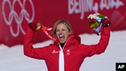 Lara Gut-Behrami, of Switzerland celebrates her gold medal in the women's super-G at the 2022 Winter Olympics, Feb. 11, 2022