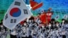 South Korea's flag bearer Kwak Yoon-gy and South Korea's flag bearer Kim A-lang lead the delegation during the opening ceremony of the Beijing 2022 Winter Olympic Games at the National Stadium in Beijing on Feb. 4, 2022. 