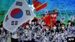 South Korea's flag bearer Kwak Yoon-gy and South Korea's flag bearer Kim A-lang lead the delegation during the opening ceremony of the Beijing 2022 Winter Olympic Games at the National Stadium in Beijing on Feb. 4, 2022. 