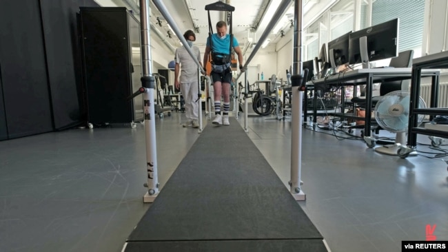 A 42-year-old patient performs training on a weight-supporting robot at Lausanne University Hospital after having received a spinal cord implant, in this undated handout photo taken in Lausanne, Switzerland.
(NeuroRestore/Jimmy Ravier/Handout via REUTERS