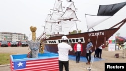 Women pose in front of a replica of the ship Elizabeth, which was called "The Mayflower of Liberia" during the Liberia bicentennial commemoration in Paynesville, a suburb of Monrovia, Liberia February 14, 2022.