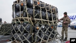 Ukrainian servicemen unpack Javelin anti-tank missiles, delivered as part of US security assistance to Ukraine, at the Boryspil airport outside Kyiv, Feb. 11, 2022.