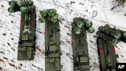In this photo taken from video provided by the Russian Defense Ministry Press Service on Thursday, Feb. 10, 2022,cCombat crews of the S-400 air defense system take up combat duty at the training ground in the Brest region during the Union Courage-2022 Rus