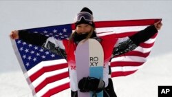 United States' Chloe Kim celebrates during the venue ceremony for the women's halfpipe at the 2022 Winter Olympics, Feb. 10, 2022, in Zhangjiakou, China.