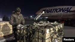Military aid, delivered as part of the United States' security assistance to Ukraine, is unloaded from a plane at the Boryspil International Airport outside Kyiv, Ukraine Feb. 13, 2022. 