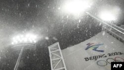 The logo for the Beijing 2022 Winter Olympic Games is displayed as snow falls ahead of the freestyle skiing women's aerials qualification at the Genting Snow Park A & M Stadium in Zhangjiakou, China, on Feb. 13, 2022.