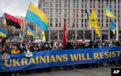 Ukrainians attend a rally in central Kyiv on February 12, 2022, during a protest in the run up to Russia's invasion of Ukraine on February 24 of that year. (Efrem Lukatsky/AP)