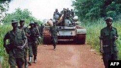 FILE - A Ugandan battalion withdraws from the northeast Bafwasende town, Democratic Republic of Congo, July 11, 2001. 