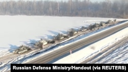 Russian tanks of the Western Military District units return to their permanent deployment sites, in an unknown location in Russia, in this still image taken from a handout video released Feb. 15, 2022.