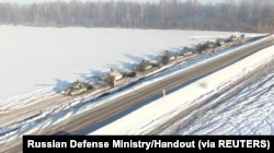 Russian tanks of the Western Military District units return to their permanent deployment sites, in an unknown location in Russia, in this still image taken from a handout video released Feb. 15, 2022.