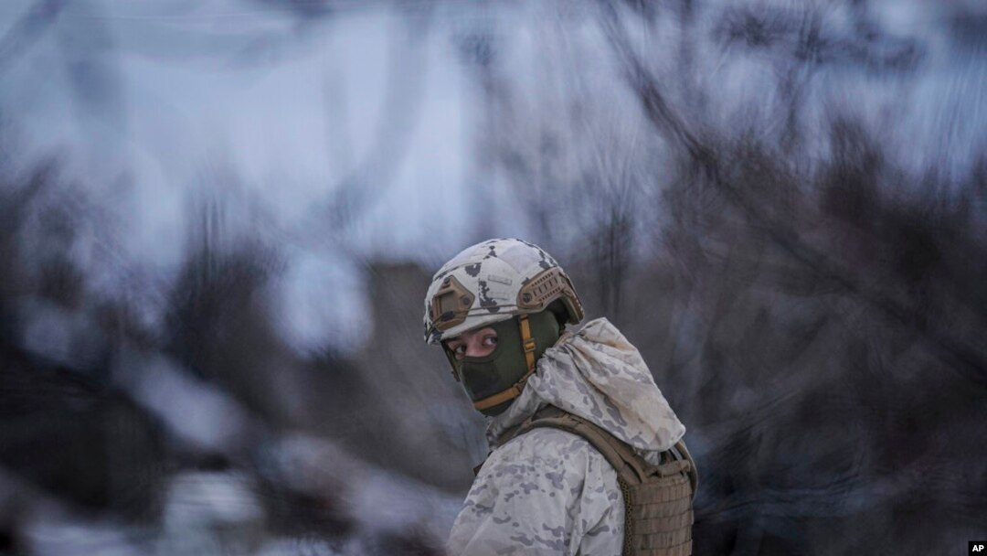 A Ukrainian serviceman provides area security during a visit by Gen. Oleksandr Pavliuk, commander of the Joint Forces Operation, to frontline positions outside Avdiivka, Donetsk region, eastern Ukraine, Feb. 9, 2022. 