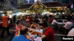 People eat at Lau Pa Sat food center in Singapore, July 29, 2016.