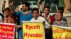 Demonstrators shout slogans in front of a Hyundai showroom during a protest against a tweet from the account of Hyundai Pakistan partner that expressed solidarity for the people of Kashmir, in Ahmedabad, India, Feb. 9, 2022. 