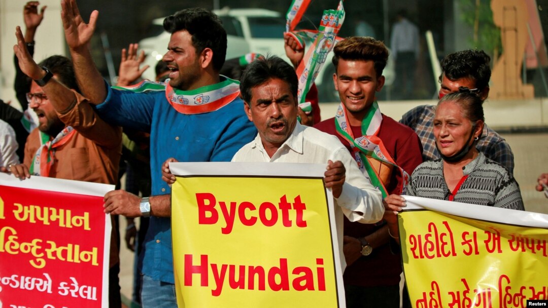 Demonstrators shout slogans in front of a Hyundai showroom during a protest against a tweet from the account of Hyundai Pakistan partner that expressed solidarity for the people of Kashmir, in Ahmedabad, India, Feb. 9, 2022. 