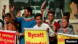 Supporters of the youth wing of India's main opposition Congress party shout slogans in front of a Hyundai showroom during a protest against a tweet from the account of Hyundai Pakistan partner that expressed solidarity for the people of Kashmir, in Ahmed