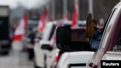 Vehicles block the route leading from the Ambassador Bridge, linking Detroit and Windsor, as truckers and their supporters continue to protest against COVID-19 vaccine mandates, in Windsor, Ontario, Canada, Feb. 9, 2022.